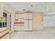 Kitchen area featuring tiled floors, white cabinets, and a microwave above the countertop at 7024 Harwick Dr, Orlando, FL 32818
