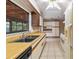 Bright kitchen with tile flooring, laminate countertops, and a large window overlooking the backyard at 7024 Harwick Dr, Orlando, FL 32818