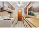 Kitchen with white appliances, light countertops, ample cabinet space, and tile flooring at 7024 Harwick Dr, Orlando, FL 32818