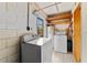Laundry room features washer, dryer, water heater, and wood shelving at 7024 Harwick Dr, Orlando, FL 32818