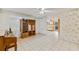 Open-concept living area with tile flooring, ceiling fan and large bookcase at 7024 Harwick Dr, Orlando, FL 32818