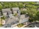 An aerial view of a home in a community surrounded by lush greenery at 704 Honeysuckle Ave, Kissimmee, FL 34747