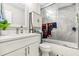 Bathroom with white cabinets, marble countertop, and glass door in the shower at 704 Honeysuckle Ave, Kissimmee, FL 34747