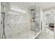 Bathroom featuring a glass shower, with marble tile and built in shelves at 704 Honeysuckle Ave, Kissimmee, FL 34747
