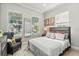 Bright bedroom with large windows, neutral colors, and comfortable furnishings at 704 Honeysuckle Ave, Kissimmee, FL 34747