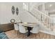 Bright dining area featuring a table with upholstered chairs and modern decor at 704 Honeysuckle Ave, Kissimmee, FL 34747