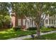 Charming two-story brick home with a well-manicured lawn and lovely green door at 704 Honeysuckle Ave, Kissimmee, FL 34747