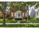 Charming two-story brick home with a well-manicured lawn and lovely green door at 704 Honeysuckle Ave, Kissimmee, FL 34747