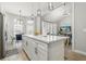 Open-concept kitchen with a view into the dining area, living room, and white quartz countertops at 704 Honeysuckle Ave, Kissimmee, FL 34747