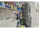 Functional laundry room with a sink, stacked washer/dryer, and ample storage at 704 Honeysuckle Ave, Kissimmee, FL 34747