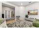 Spacious living room with a keyboard, TV, stylish decor, and modern gray and white color scheme at 704 Honeysuckle Ave, Kissimmee, FL 34747