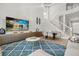 Bright living room with modern decor, vaulted ceiling, and staircase at 704 Honeysuckle Ave, Kissimmee, FL 34747