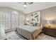 Bedroom featuring tray ceilings, large windows, and decor at 704 Honeysuckle Ave, Kissimmee, FL 34747