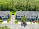 Aerial view of townhomes surrounded by a lush tree canopy, marked parking, and well-maintained landscaping at 707 Evening Sky Dr, Oviedo, FL 32765