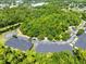 Aerial view of tree-lined community with townhomes, mature trees, ponds, and well-maintained landscaping at 707 Evening Sky Dr, Oviedo, FL 32765