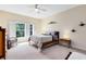 Cozy bedroom with plush carpet, a ceiling fan, neutral walls, and bright natural light at 707 Evening Sky Dr, Oviedo, FL 32765