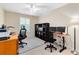 Office space with ceiling fan, 2 desks, a storage shelf, and carpeted floors at 707 Evening Sky Dr, Oviedo, FL 32765