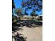 Exterior view of a clubhouse featuring a well-maintained brick driveway, lush landscaping, and mature trees at 724 Barrington Cir, Winter Springs, FL 32708