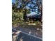 A street view of the restaurant surrounded by mature trees and lush landscaping at 724 Barrington Cir, Winter Springs, FL 32708