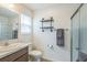 Functional bathroom featuring a glass-enclosed shower and modern floating shelves at 747 Louise Ln, The Villages, FL 32163