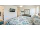 Cozy bedroom showcasing a mounted TV and stylish dresser with a mirror at 747 Louise Ln, The Villages, FL 32163