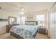 Comfortable bedroom with ceiling fan, bright decor, and plenty of natural light, perfect for relaxation at 747 Louise Ln, The Villages, FL 32163