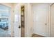 Hallway view with a glimpse into bedroom, laundry closet and other doorways at 747 Louise Ln, The Villages, FL 32163