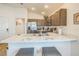 Bright kitchen featuring brown cabinets, stainless steel appliances, and an island with seating for casual dining at 747 Louise Ln, The Villages, FL 32163