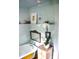 Cozy bathroom showcasing painted tub, shelving with decor, and decorative mirror at 748 W Florence Ave, Deland, FL 32720