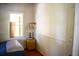 Bright bedroom featuring a window, side table, and bead-board paneling at 748 W Florence Ave, Deland, FL 32720