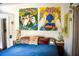 Inviting bedroom featuring colorful pillows, a blue comforter and heron-themed artwork at 748 W Florence Ave, Deland, FL 32720