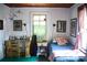 Functional bedroom with desk, single bed, artwork, and window with curtains at 748 W Florence Ave, Deland, FL 32720