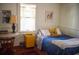 Bedroom with a bed, side table, stylish desk, and natural light streaming through the window at 748 W Florence Ave, Deland, FL 32720