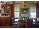 Charming dining area with hardwood floors, bright windows, and period furnishings at 748 W Florence Ave, Deland, FL 32720
