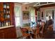 Charming dining area with hardwood floors, bright windows, and period furnishings at 748 W Florence Ave, Deland, FL 32720