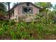 Charming home exterior with well-maintained lawn and colorful landscaping in foreground at 748 W Florence Ave, Deland, FL 32720