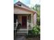 Inviting front porch with stairs, plants, and charming details on a well-maintained cottage at 748 W Florence Ave, Deland, FL 32720
