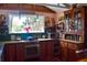 Charming kitchen with vintage cabinets, stainless steel appliances, and bright window at 748 W Florence Ave, Deland, FL 32720