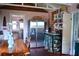 Open concept kitchen with stainless steel refrigerator, dining table, and vintage cabinets at 748 W Florence Ave, Deland, FL 32720