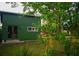 Exterior angle view of the backyard outbuilding with a simple window and door at 748 W Florence Ave, Deland, FL 32720