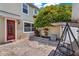 Cozy backyard featuring brick patio, a mature tree, and a porch swing at 8445 Leeland Archer Blvd, Orlando, FL 32836