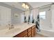 Bathroom featuring double vanity and a shower with a leaf-themed curtain at 8445 Leeland Archer Blvd, Orlando, FL 32836