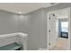 Hallway featuring a white door and access to carpeted area at 8445 Leeland Archer Blvd, Orlando, FL 32836