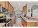 Bright kitchen featuring stainless steel appliances and a cozy eat-in area with natural light at 8445 Leeland Archer Blvd, Orlando, FL 32836