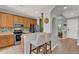 Well-lit kitchen features wood cabinetry, and an opening providing views to the dining area at 8445 Leeland Archer Blvd, Orlando, FL 32836