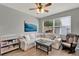 Cozy living room features a plush white sofa, and a window providing ample natural light at 8445 Leeland Archer Blvd, Orlando, FL 32836
