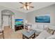 Bright living room with plush white sectional sofa and a large screen television for entertainment at 8445 Leeland Archer Blvd, Orlando, FL 32836