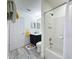 Neat bathroom features a tub and shower combination and gray plank flooring at 8518 La Isla Dr, Kissimmee, FL 34747