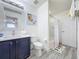 Bathroom features a vanity with a quartz countertop, a toilet, and a shower-tub combo with neutral paint tones at 8518 La Isla Dr, Kissimmee, FL 34747