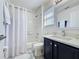 A full bathroom featuring modern fixtures, a tub and shower combo, and a vanity with ample counter space at 8518 La Isla Dr, Kissimmee, FL 34747